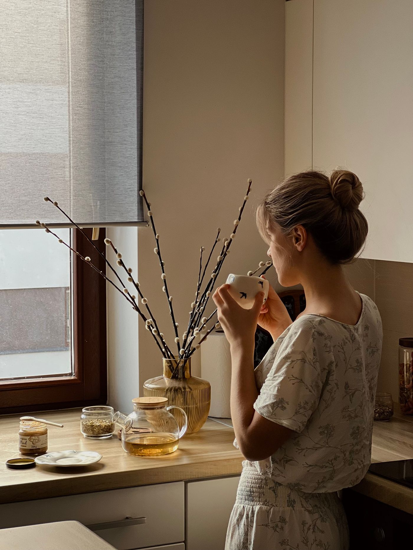 A woman with tea in soft morning light. Not a portrait of Leticia.